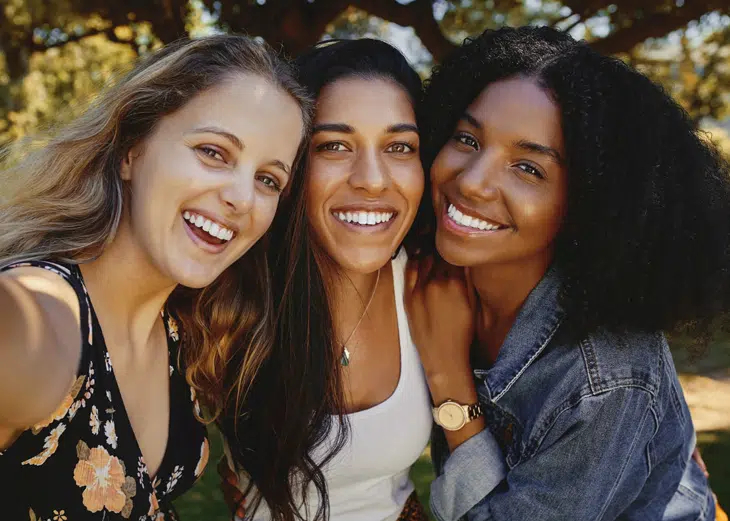 Happy woman showing off her improved smile after treatment at Legacy Dental