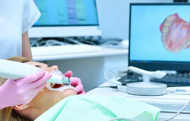 dental hygienist in Cary, NC examining a patient using an intraoral camera
