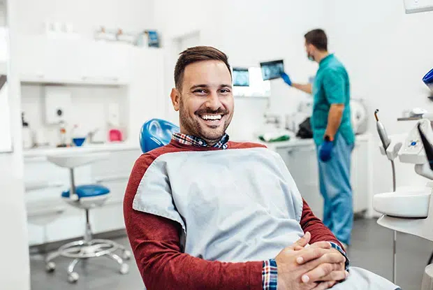 Friendly oral cancer checkup with smiling patient in Cary NC