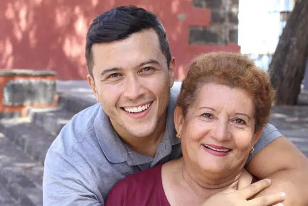 Mother and son smiling confidently after preparing their smiles for senior pictures with dental care in Cary, NC.