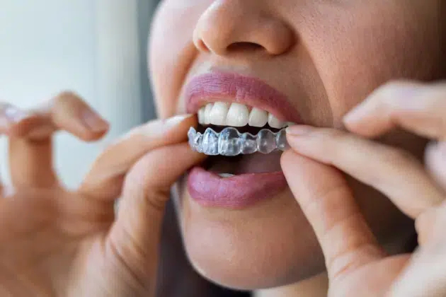 A woman in Cary, NC wearing Invisalign for straightening teeth